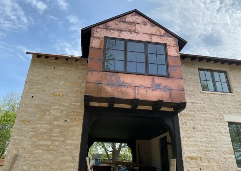 Copper metal panel facade on a stone building for Skylight Installation in Marshfield