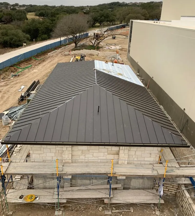 Metal roof new construction with scaffolding in Marshfield